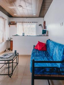 a living room with a blue couch and a table at C9 Anjuna in Anjuna