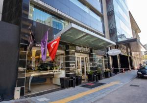 a store with flags in front of a building at MY Hotel in Izmir