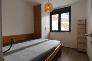 a bedroom with a bed and a window at Ravna Planina in Pale