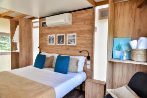 a bedroom with a bed with blue pillows at The Park - Silang in Silang +63 photos