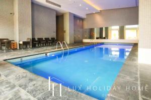 a large swimming pool in a hotel lobby at LUX The Elegant DIFC Suite 2 in Dubai
