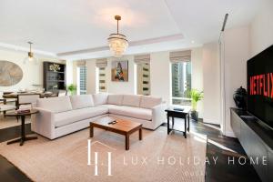a living room with a white couch and a table at LUX The Elegant DIFC Suite 2 in Dubai
