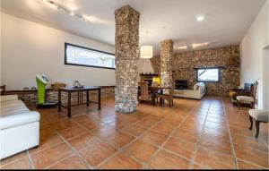 a living room with a table and a stone pillar at Cortijo Andaluz Doña Adela in Almería