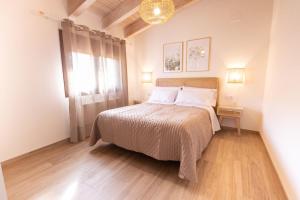 a bedroom with a bed and a window at El sueño del Búho 4. Ático con chimenea y terraza. in Beceite