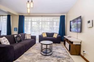 a living room with a couch and a table at JCA APARTMENTS in Nairobi