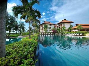 a large swimming pool in front of a house at 3BR garden pool villas in beach resort in Da Nang