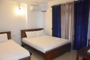 Giường trong phòng chung tại Anuradhapura Silverline Guest