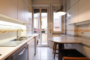 a kitchen with a sink and a counter top at HomNest I S.Ambrogio Elegant Apt in Milan