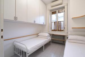 Voodi või voodid majutusasutuse HomNest I S.Ambrogio Elegant Apt toas