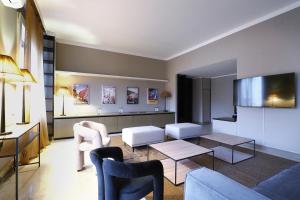 a living room with a couch and chairs at HomNest I S.Ambrogio Elegant Apt in Milan