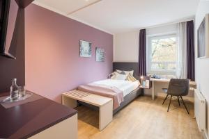 Rúm í herbergi á Hotel Blumlage