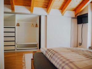 a bedroom with a bed and a large window at Appartement zur Linde in Marktschellenberg