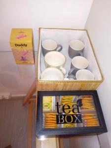 a box of cups and a magazine on a table at Chez Paul et Mélusine in Périgueux
