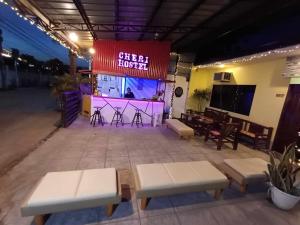 a stage with benches and a sign for a guest house at CheRi Backpackers Hostel in Moalboal