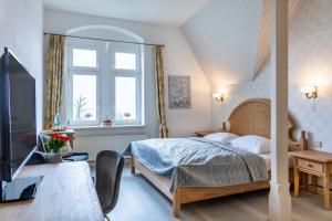 Postel nebo postele na pokoji v ubytování Schlossberg-Hotel Garni
