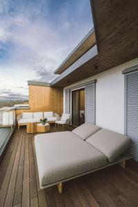 a bedroom with a bed on a wooden deck at Adults Only Hotel Reiters Supreme in Bad Tatzmannsdorf