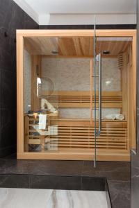 a bathroom with a shower with a glass door at FREE Parking - 5 Star - Sauna Luxury Apartment in Milan