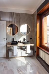 a bathroom with two sinks and two mirrors at FREE Parking - 5 Star - Sauna Luxury Apartment in Milan