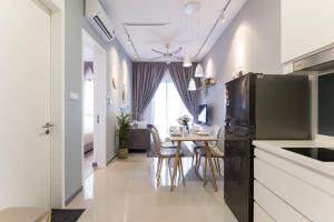 una cucina e una sala da pranzo con tavolo e frigorifero di NEW! Cozy & Warm Scandinavian Suites walk to LRT a Kuala Lumpur