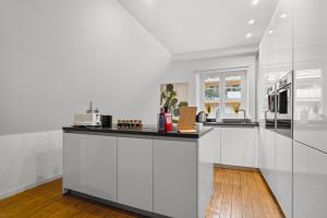 a kitchen with white cabinets and a counter top at Traumhaft gelegene Altbau-Wohnung im Herzen von Weinheim in Weinheim