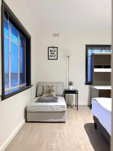 a white room with a bed and a window at Cozy Villa Near Chadstone Fashion Capital in Chadstone