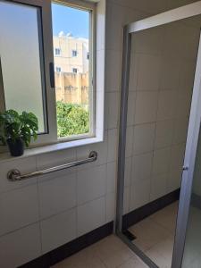 a shower in a bathroom with a window at The Misraħ at Rabat in Rabat