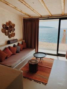 a living room with a couch and a view of the ocean at Townhouse in Bodrum City