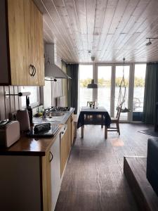 a kitchen with a table in the middle of a room at Floating Home Valentinswerder in Berlin