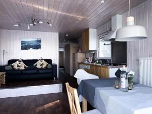 a living room and kitchen with a couch and a table at Hausboot Insel Valentinswerder Berlin in Berlin