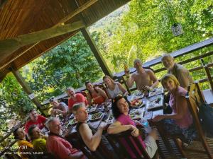 a group of people sitting around a table with food at Bambua Nature Cottages in Puerto Princesa City