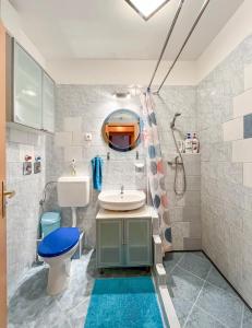 a bathroom with a sink and a toilet and a mirror at Lovely home - Free parking in Budapest