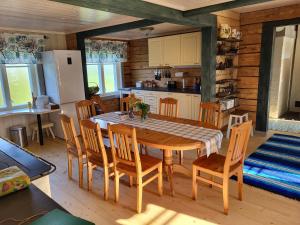 a kitchen and dining room with a table and chairs at Saadumäe Holiday House in Saareküla