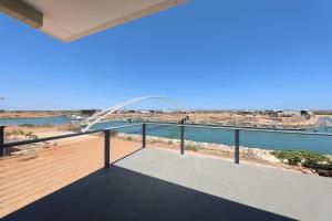 a balcony with a view of the water and a bridge at Exmouth Marina Escape in Exmouth