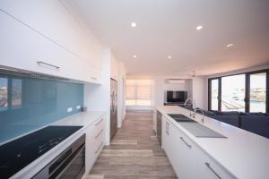 a kitchen with white countertops and a living room at Exmouth Marina Escape in Exmouth