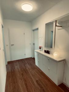 an empty room with a dresser and a mirror at Allegra Appartements in Nohfelden