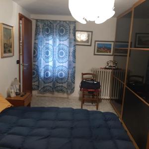 a bedroom with a blue bed and a blue curtain at Casa belvedere in Sanfront
