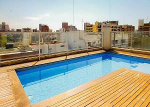 a large swimming pool on the roof of a building at Regatas Las Cañitas Suites in Buenos Aires