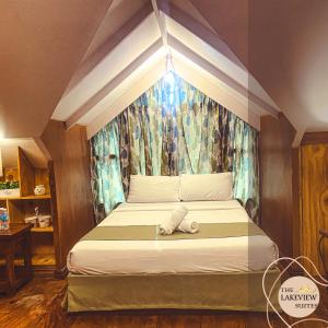 a bed with a stuffed animal on it in a room at The Lakeview Suites in Tagaytay