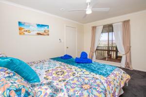 a bedroom with a bed with a blue object on it at Pecan Hill BNB in Toodyay