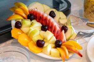 a plate of fruit on a table at Studios Vrionis Panoramic Sunset in Kothréas