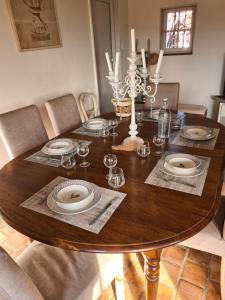 a dining room table with plates and glasses on it at Gîte de la Besbre in Saint-Pourçain-sur-Besbre