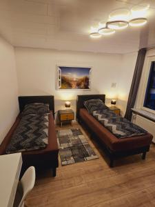 a bedroom with two beds and a couch and a window at B02 Schöne Apartments in Barsinghausen in Barsinghausen