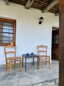 a table and two chairs on a patio at Lila's Guest House in Mikrós Prínos