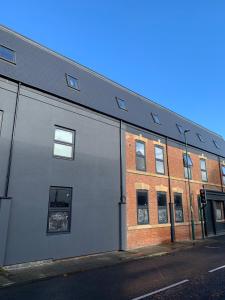 a white building with windows on a street at OYO The Contractor Hotel in South Bank