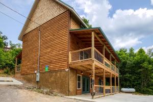 a large wooden building with a balcony at Pooling Around #200 in Gatlinburg