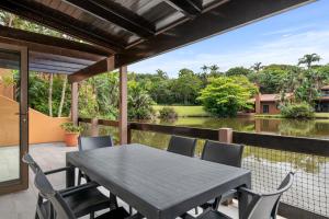 a table and chairs on a patio with a view of the water at San Lameer Villa 1908 - 2 Bedroom Classic - 4 pax - San Lameer Rental Agency in Southbroom