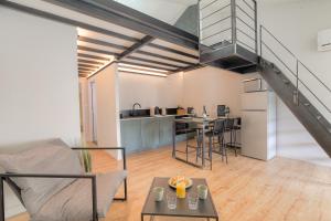 uma sala de estar e cozinha com uma escada num loft em L Original - TravelHome - Free wifi - 6 travelers em Villefranche-sur-Saône