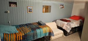 a bedroom with two beds and a chair in it at Chambre d'Hôtes le Gachignard in Courlay