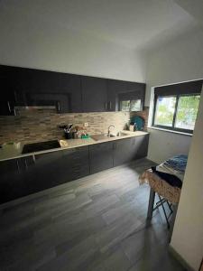 a kitchen with a sink and a counter top at Spacious House 3 Rooms in Barreiro