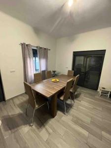 a dining room with a wooden table and chairs at Spacious House 3 Rooms in Barreiro
